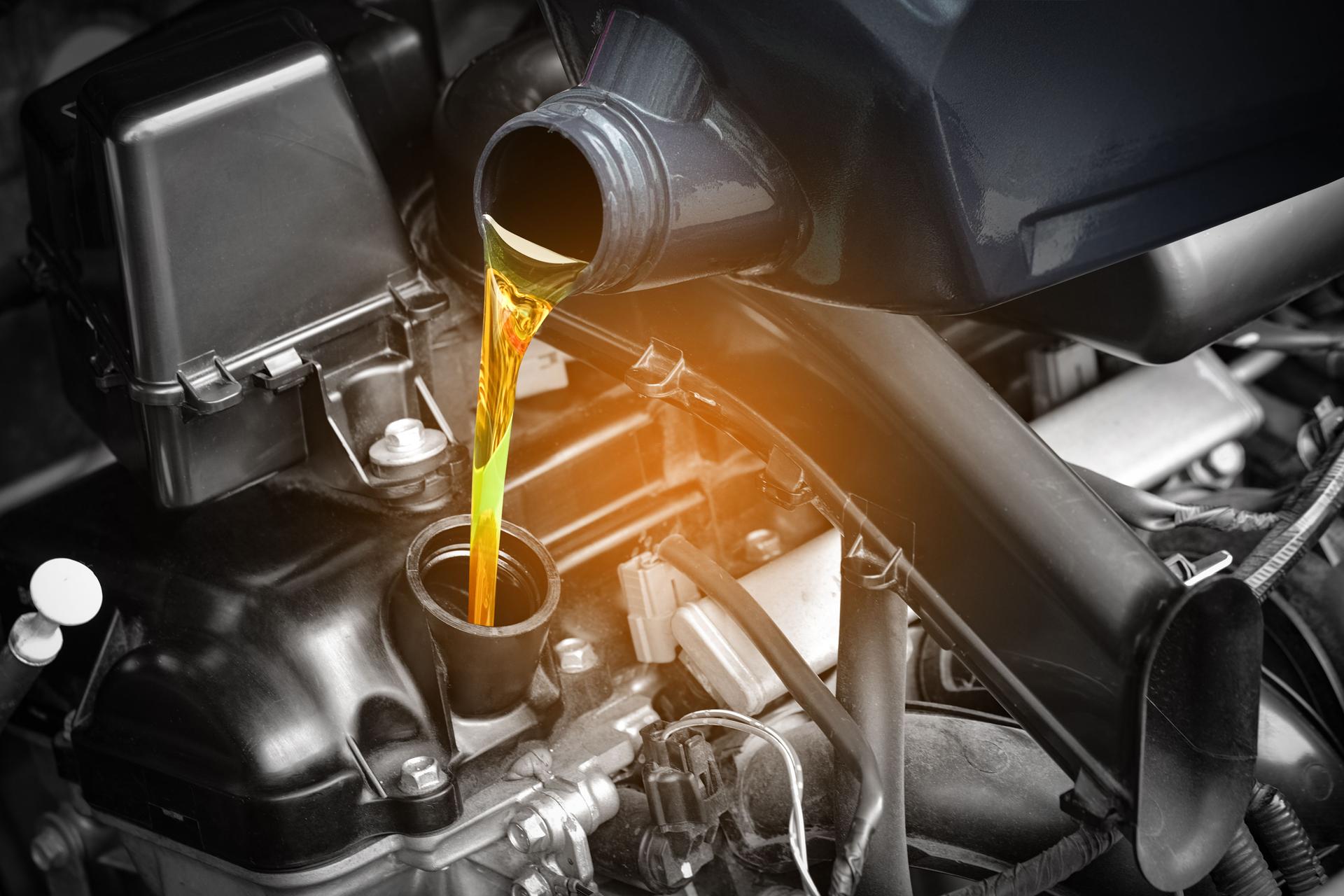 Refueling and pouring oil quality into the engine motor car Transmission and Maintenance Gear.Energy fuel concept.